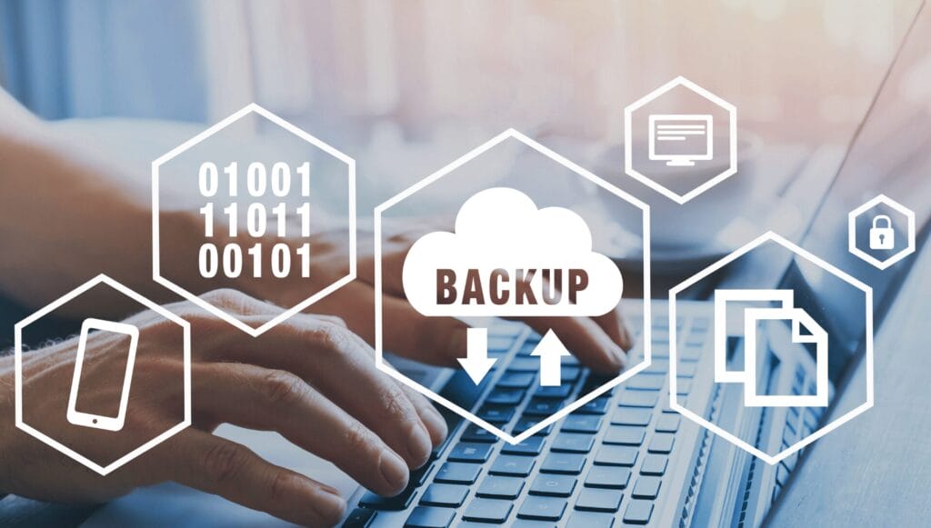 Hands typing on a laptop with overlay icons for cloud backup, file storage, security, and devices, with the word “BACKUP” in the center.